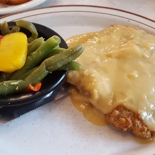 Chicken fried steak with chicken gravy and their veggie medley accompaniment