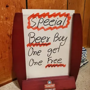 a sign that reads special beer buy one get one free