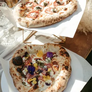 two pizzas on plates