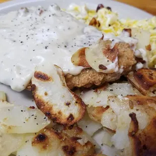 Underneath all that good white milk gravy is chicken fried steak,  scrambled eggs and great breakfast potatoes!