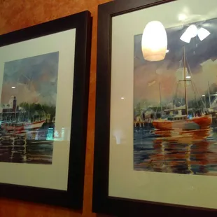 two framed paintings of boats