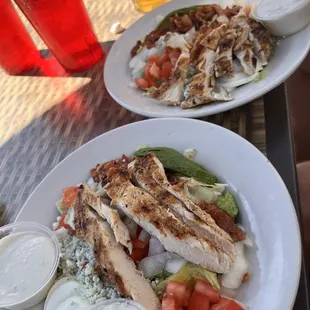 The huge Cobb salad split in two portions. The blue cheese dressing is actually gorgonzola and it&apos;s amazing!