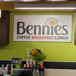a view of a counter with a sign that says bennies coffee breakfast lunch