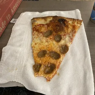 One slice on a hotel hand towel folded for size comparison (slice)
