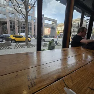 a man sitting at a table in front of a window