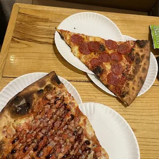 two slices of pizza on paper plates