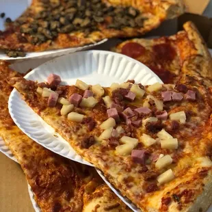 three slices of pizza on paper plates
