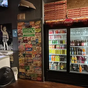 a refrigerator with sodas and sodas