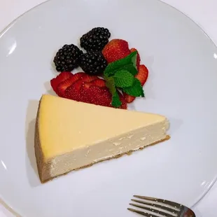 a piece of cheesecake and berries