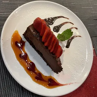 Chocolate mousse cake with homemade caramel and raspberry sauce