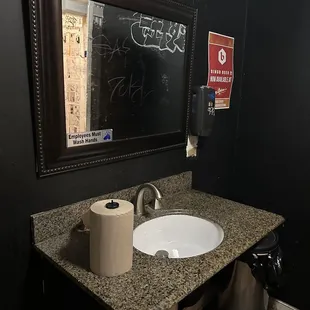 a bathroom with a chalkboard on the wall