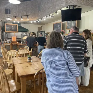 a group of people standing around a table