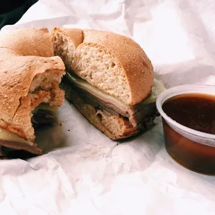 a half eaten sandwich and a cup of coffee