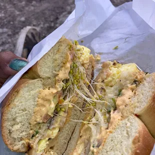 Turkey Spinach Wrap made on an onion bagel, with scrambled egg and sprouts added