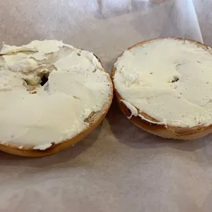 Plain bagel with cream cheese perfectly spread by the owner