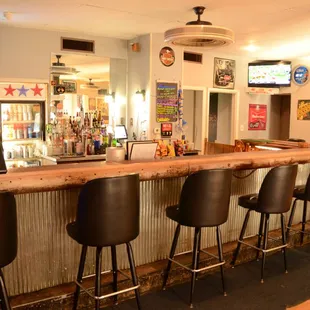 a bar with black chairs