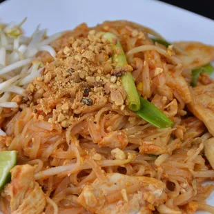 a plate of noodles with meat and vegetables