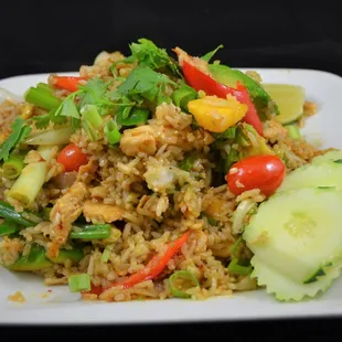 a plate of fried rice and vegetables