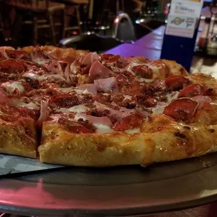 Large pizza with pepperoni, ham and bacon