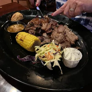Brisket, corn on the cob, cole slaw, cornbread