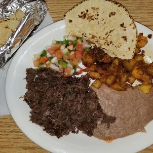 Barbacoca plate with barbacoca, potatoes, refried beans, flour tortilla and Pico