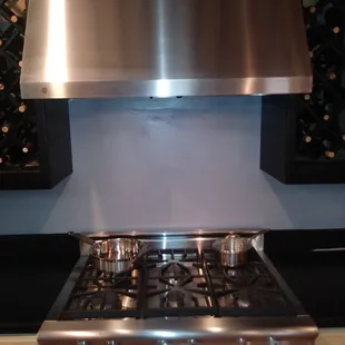 A beautiful cook top and hood we have on display. All floor models are on sale with warranty still.