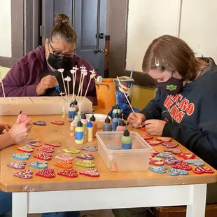 Studio staff creating heart ornaments