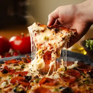 a slice being lifted from a pizza