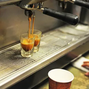 a person pouring a cup of coffee