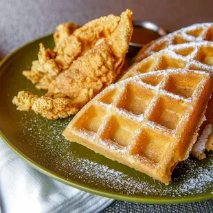 a plate of waffles and fried chicken