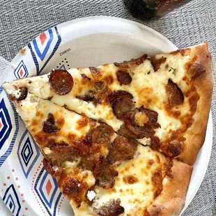 two slices of pizza on a paper plate