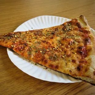 Tasteless, burnt pizza these clowns charged me $3.40 even though their sign sez 3 bucks on May 25, 2023.