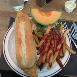 a plate of french fries and a sandwich
