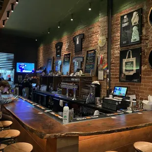 a bar with people sitting at the bar