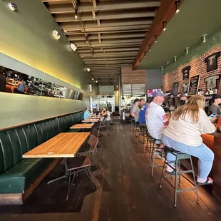 The interior with booths along wall and spots at the bar to eat