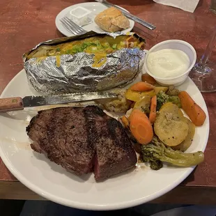 Sirloin steak, vegetables and loaded baked potato