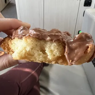 Chocolate glazed donut -- look how light fluffy it is inside! (Background is our RV, not the donut shop)