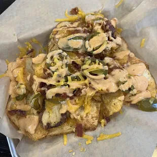 Loaded chips with their famous bucket sauce!