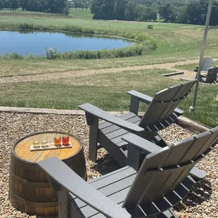 two adiron chairs and a fire pit