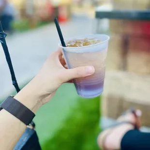 a person holding a drink