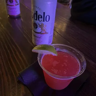 Cosmopolitan cocktail and beer. Order at the bar.