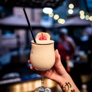 a hand holding a drink