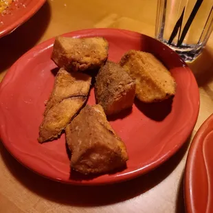 a plate of fried food and a glass of water
