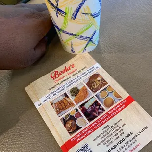 a menu and a cup of coffee