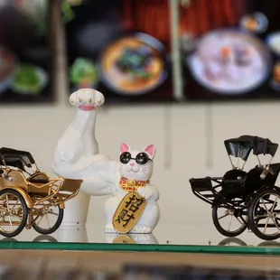 a cat figurine and a horse drawn carriage