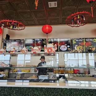 a restaurant counter with asian food