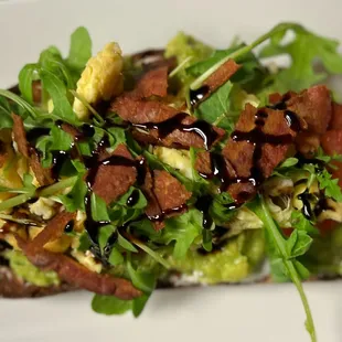 avocado toast with bacon and greens