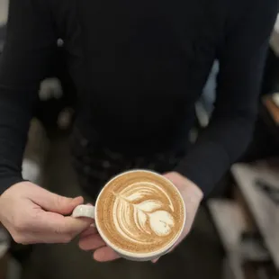 a person holding a cup of coffee