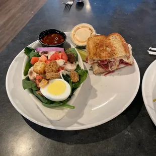 Half a Reuben with a spinach salad