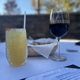 a glass of wine and a sandwich